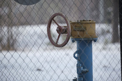 Close-up of rusty metal fence during winter