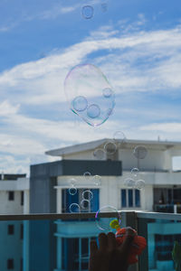 Soap bubbles are floating with apartment background.