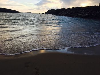 Scenic view of beach against sky during sunset