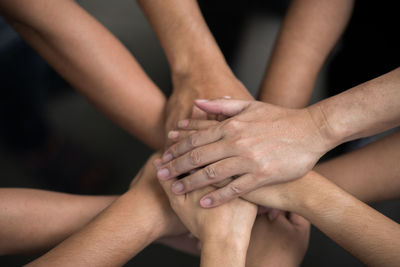 Closes-up of colleagues stacking hands