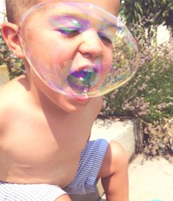 Portrait of beautiful young woman with bubbles