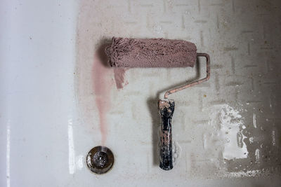 High angle view of paint roller in bathtub