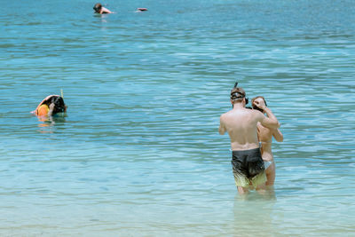 Two men swimming in sea