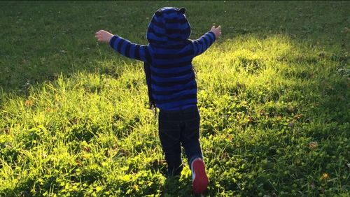Girl standing on grassy field