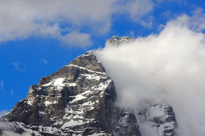 Low angle view of snowcapped mountain against sky