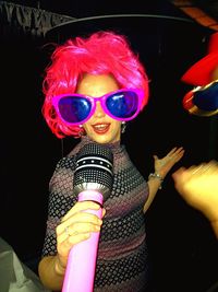 Low angle view of woman holding sunglasses