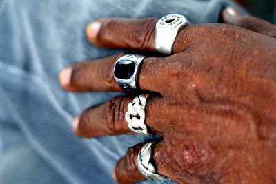 Cropped hand wearing rings