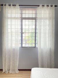 White curtain on bed at home