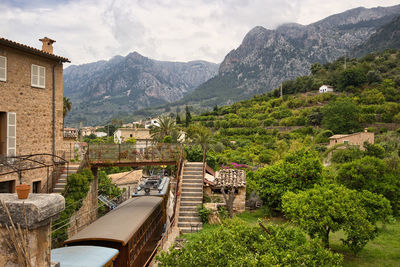 Scenic view of building and mountains against sky