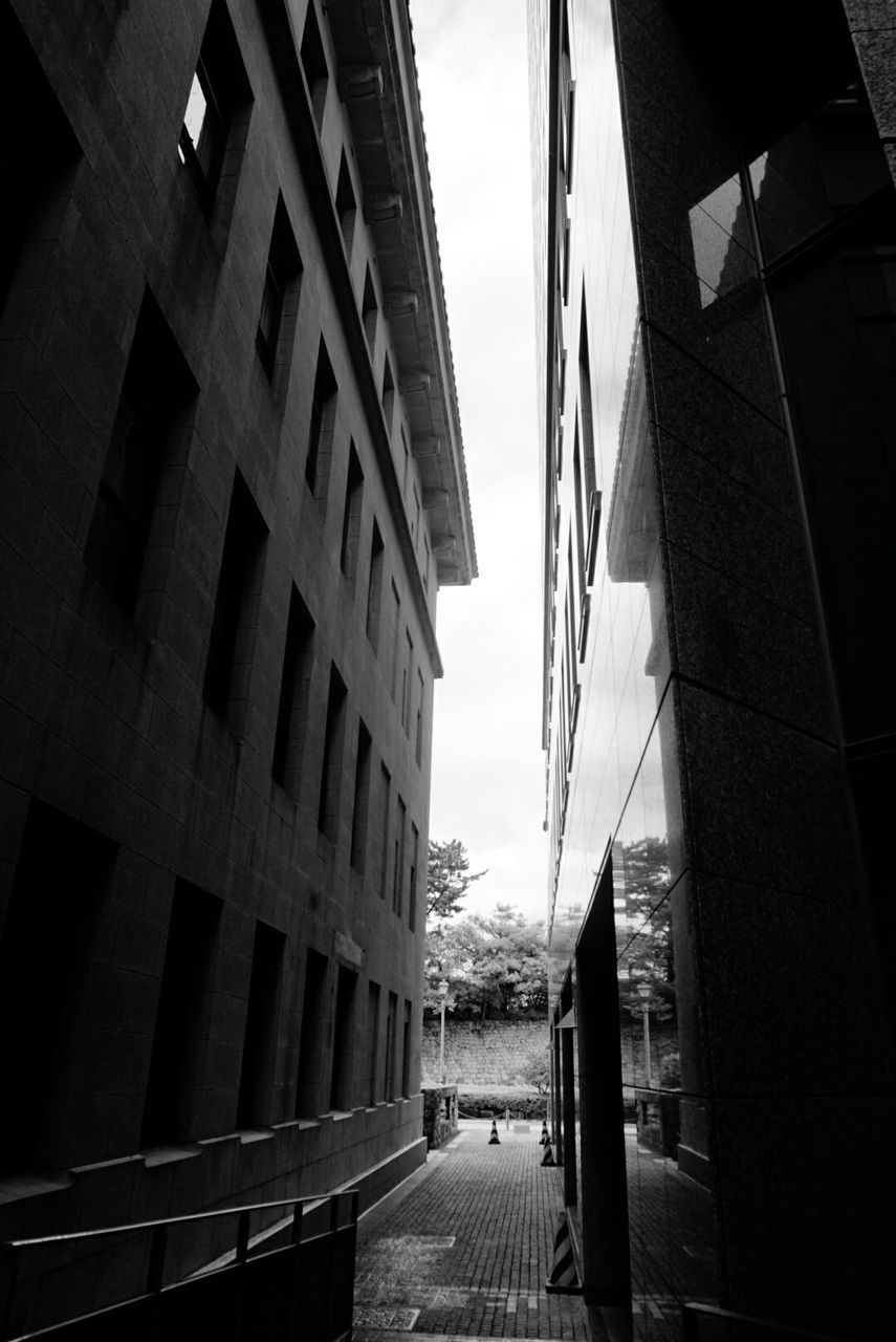 architecture, built structure, building exterior, transportation, the way forward, connection, bridge - man made structure, city, railing, sky, men, diminishing perspective, building, incidental people, day, low angle view, lifestyles, modern