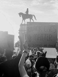 People on city street against sky