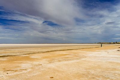 Scenic view of salt lake against sky