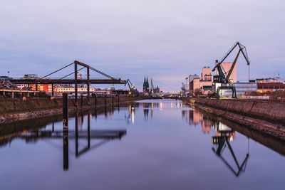 Bridge over river against sky during sunset