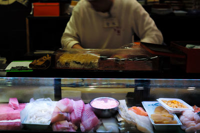 Midsection of ice cream for sale at market stall