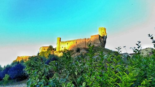 Low angle view of built structure against clear blue sky