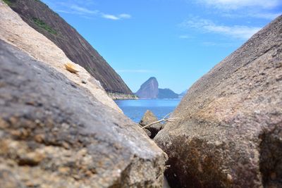 Close-up of rocks by sea against sky