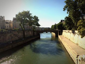 River in city against clear sky