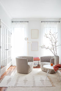 Vignette of bright, white living area with modern furnishings
