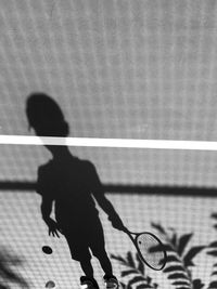 Shadow of a boy playing tennis