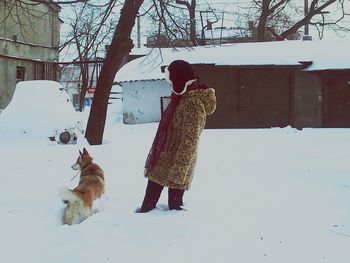 Woman standing on snow covered landscape