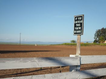 Low angle view of road sign against clear sky