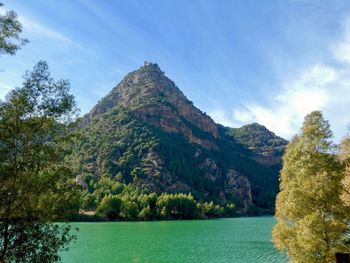 Scenic view of lake and trees against sky