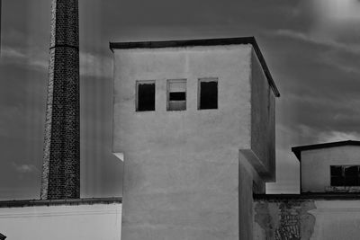 Low angle view of building against cloudy sky