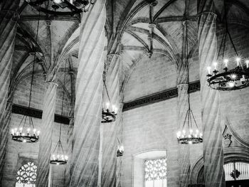 Low angle view of illuminated lights hanging on ceiling in building