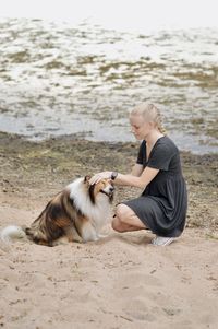 Young woman with dog on beach
