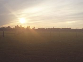 Scenic view of field against sky during sunset