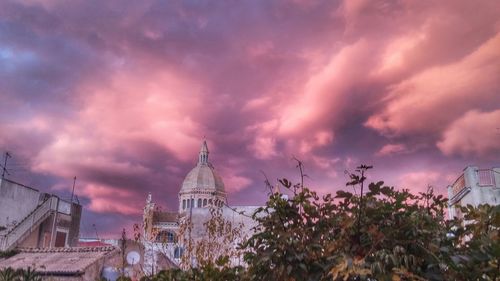 Buildings against cloudy sky