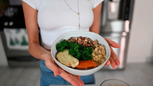 Midsection of woman holding food