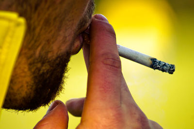 Cropped image of man smoking cigarette