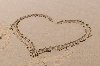 Directly above shot of heart shape on sand