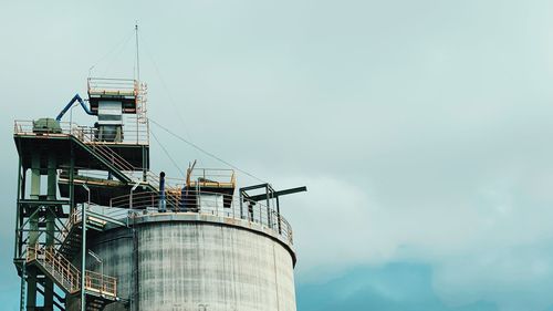 Low angle view of factory against sky