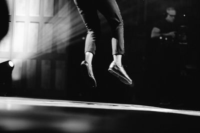 Low section of woman jumping