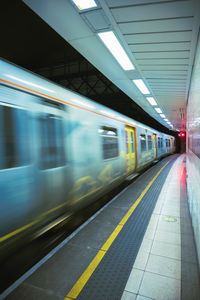 Blurred motion of train at railroad station