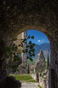 Entrance of arch bridge against blue sky