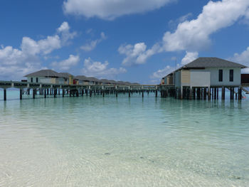 View of swimming pool by sea against sky