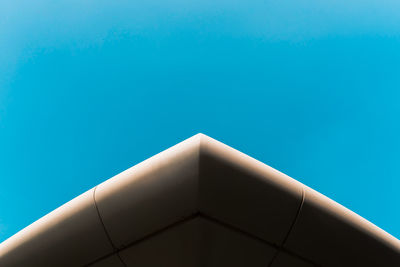 Low angle view of modern building against clear blue sky