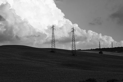 Smoke emitting from chimney on field against sky