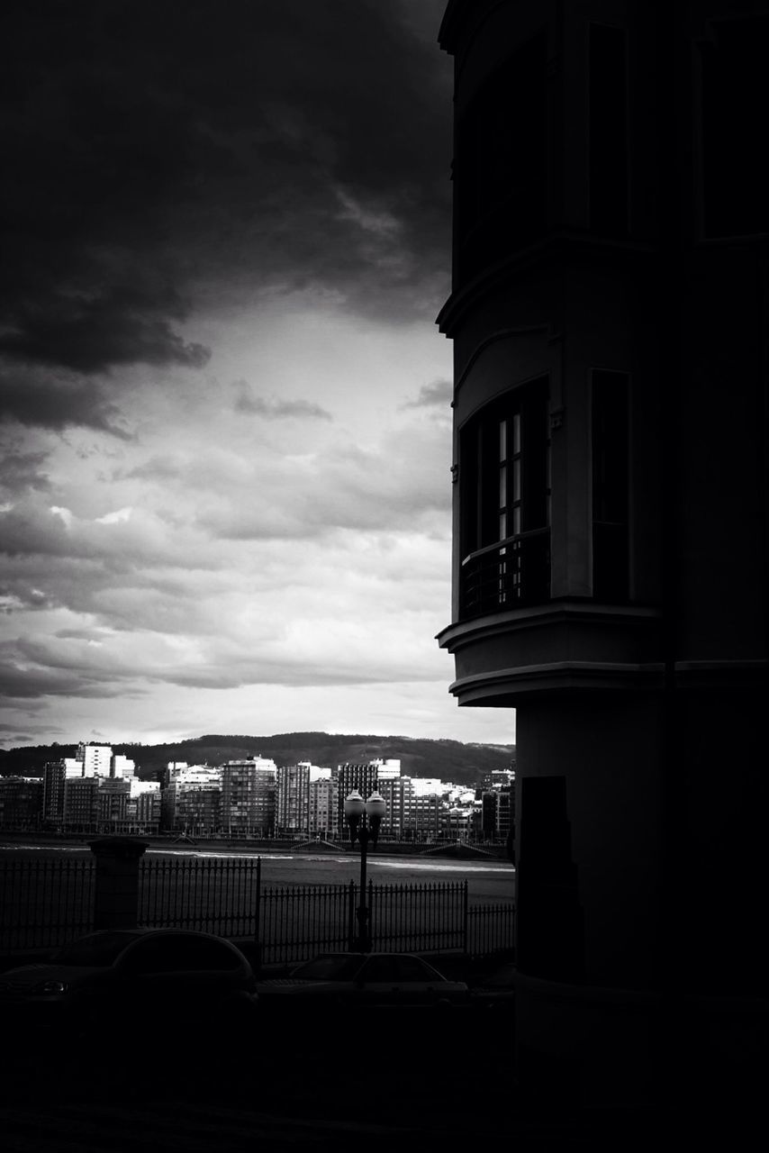 architecture, built structure, sky, building exterior, railing, cloud - sky, cloud, cloudy, sea, city, water, building, outdoors, window, horizon over water, incidental people, day, nature, overcast, dusk