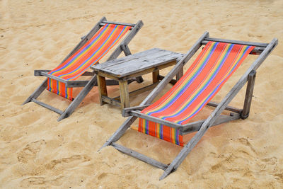 High angle view of empty deck chairs at beach