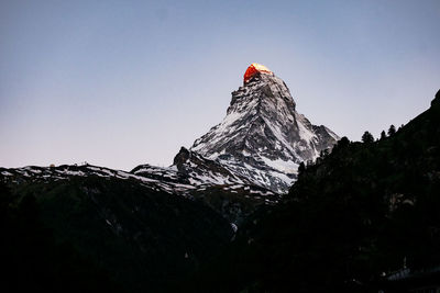 Scenic view of snowcapped mountains against clear sky