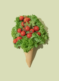 Ice cream cone with lettuce and cherry tomatoes. flat lay. nature summer concept.