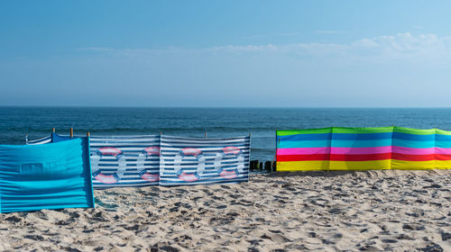 Beach screen on the polish beach on a sunny summer day in the background beautiful sea.