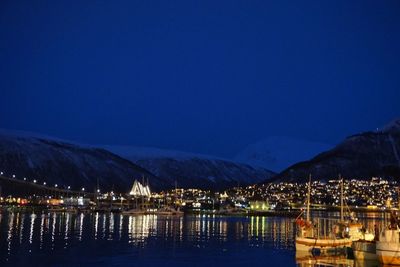 Scenic view of illuminated mountains against clear blue sky at night