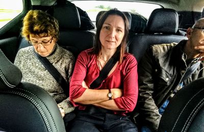 Happy woman sitting in car