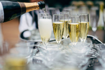 Pouring and serving champagne in a luxury social events like weddings and party.