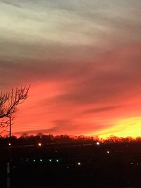 Silhouette landscape against dramatic sky during sunset